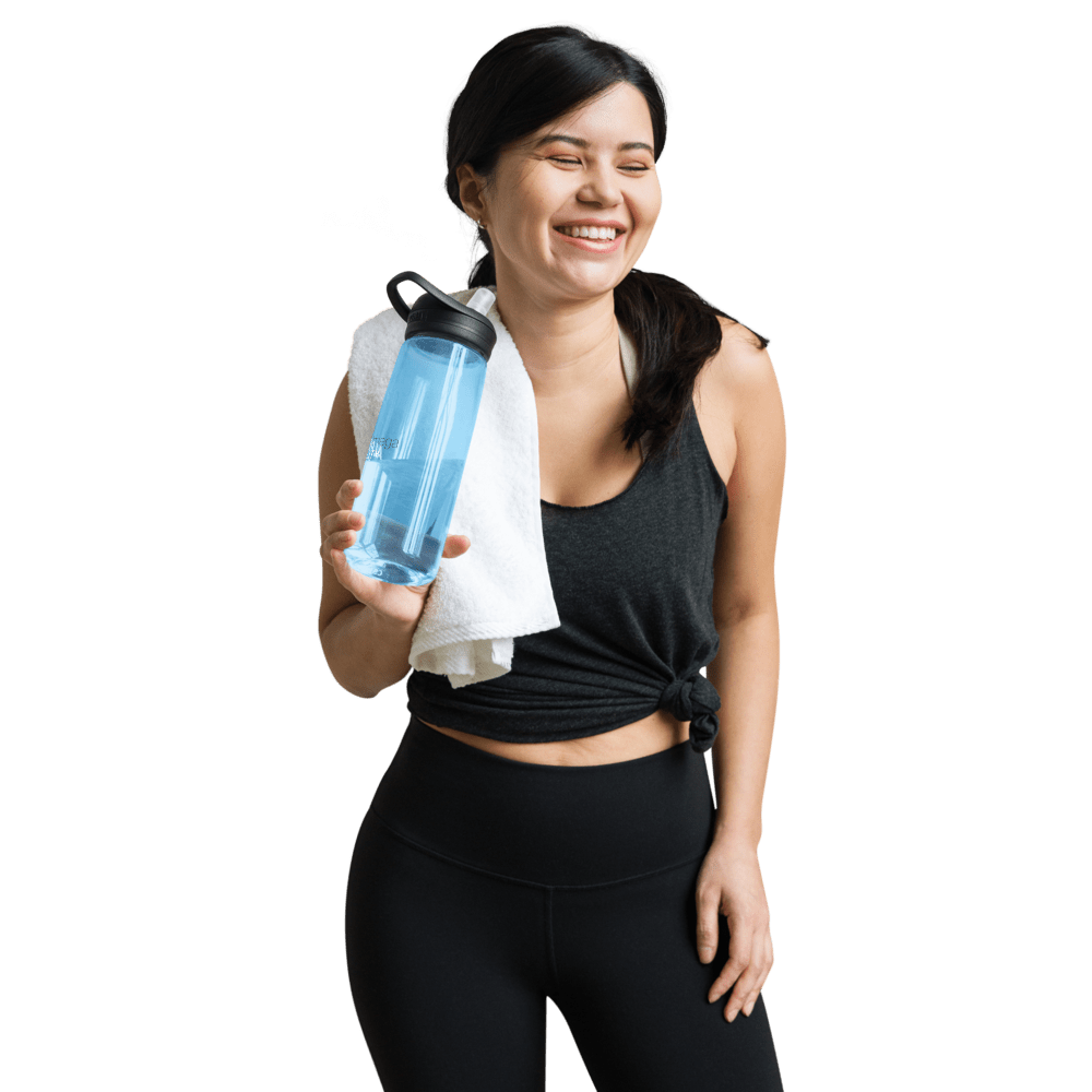 Smiling woman in activewear holding a premium sports water bottle with a towel around her neck
